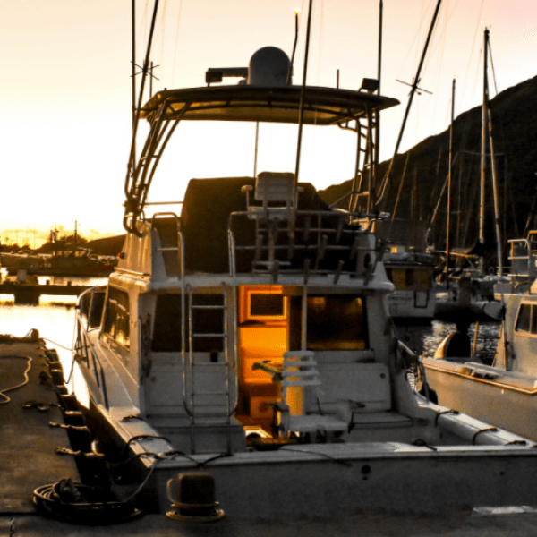 a boat is docked next to a body of water